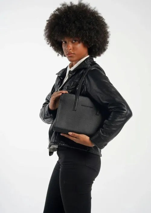 A woman carrying a black shoulder sling bag