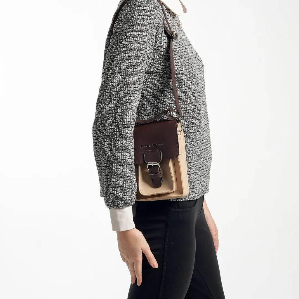 A lady holding a mini sling bag 
#color_affogato