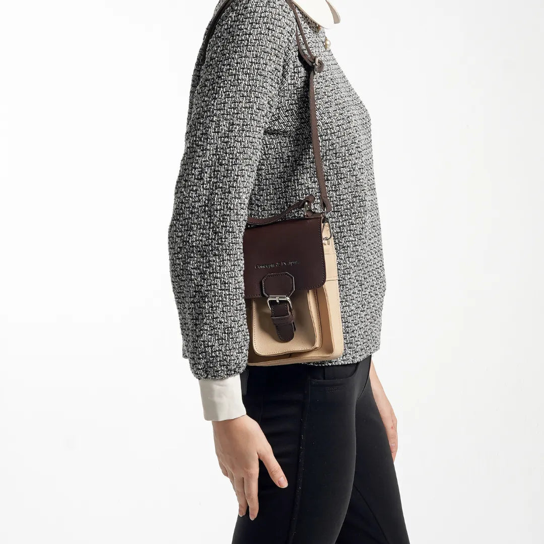 A lady holding a mini sling bag 
#color_affogato
