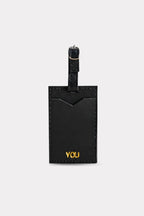 Black luggage tag with 'YOU' engraved on a white background