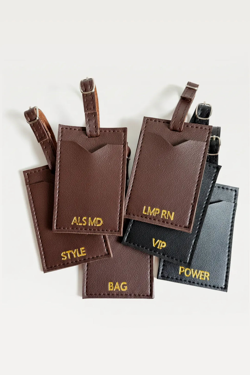 Set of brown and black leather luggage tags with text on a white background
#global