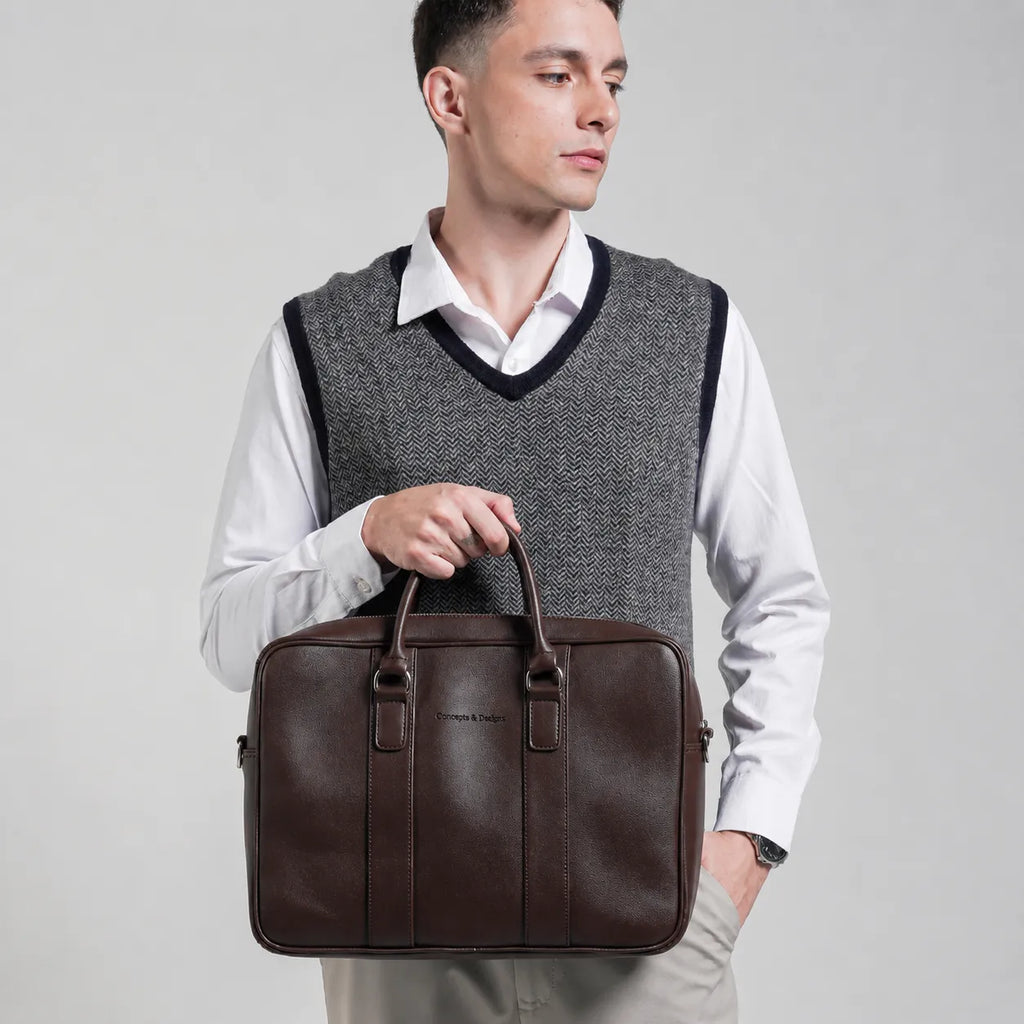 Man holding a brown leather briefcase against a plain background
#color_brown