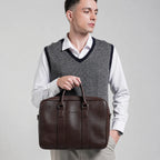 Man holding a brown leather briefcase against a plain background
#color_brown