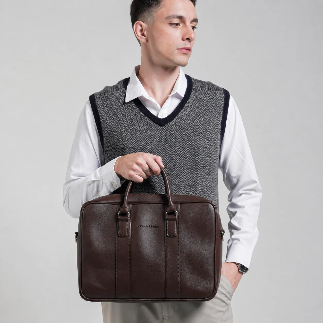 Man holding a brown leather briefcase against a plain background
#color_brown
