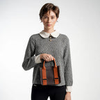 Woman holding a brown leather bag against a white background
#color_espresso