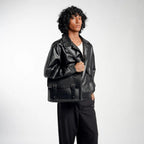 Man wearing a black leather satchel bag on a white background
#color_midnight