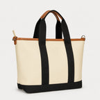 Beige tote bag with black straps and trim on a white background
#color_malibu