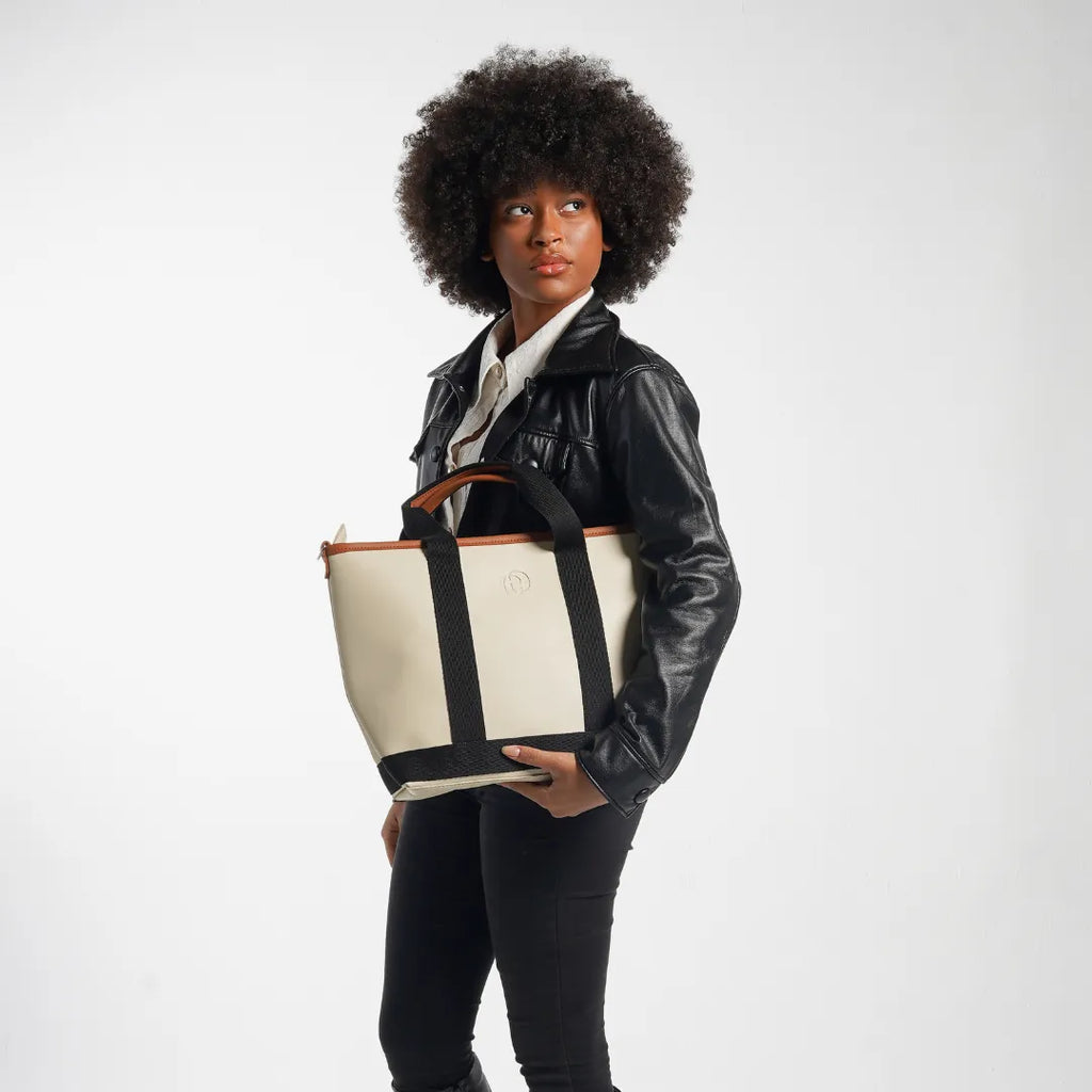 Person holding a large tote bag with a white background
#color_malibu