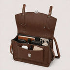 Brown leather bag with compartments and items on a light background
#color_dark brown