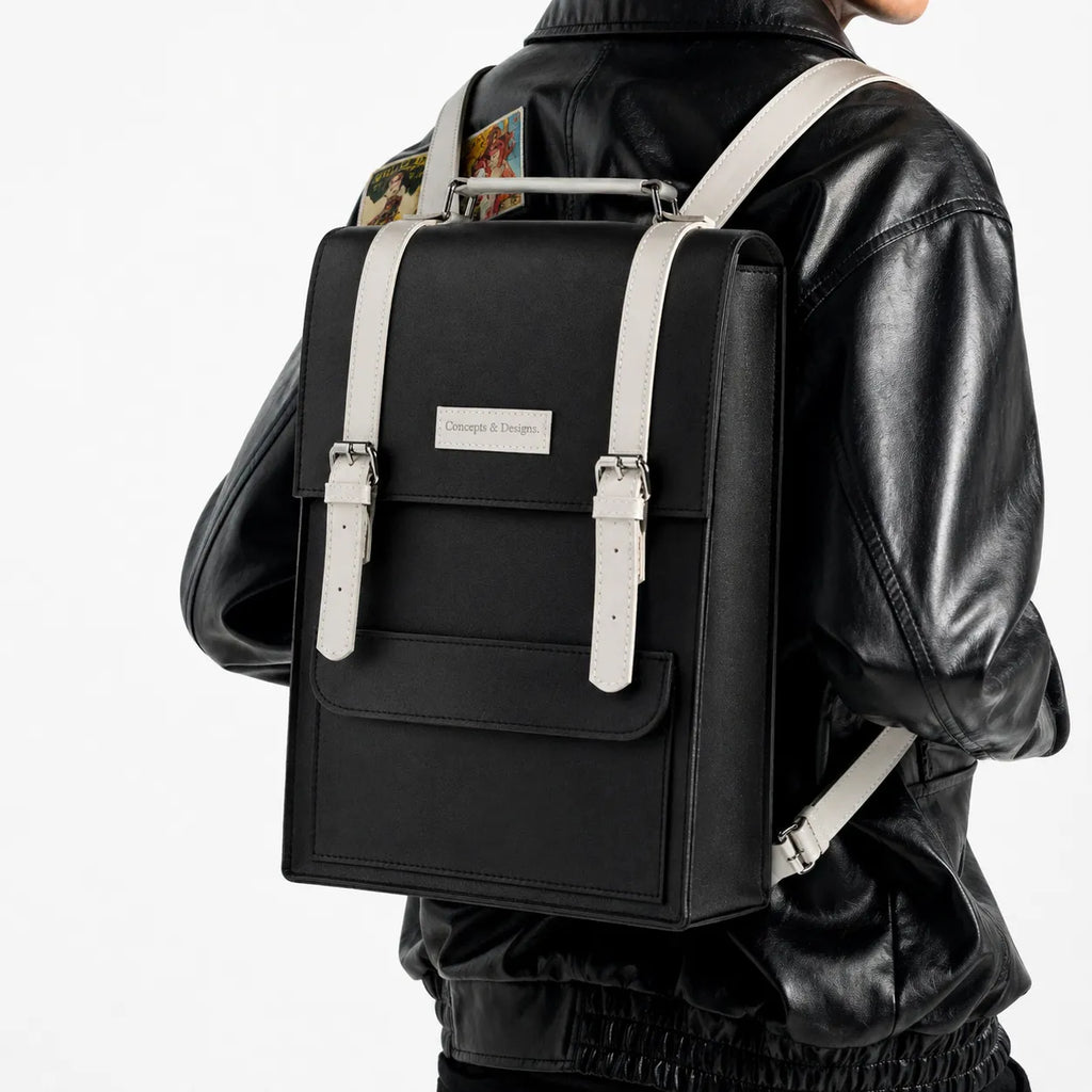 Person wearing a black backpack with white straps on a white background
#color_charcoal