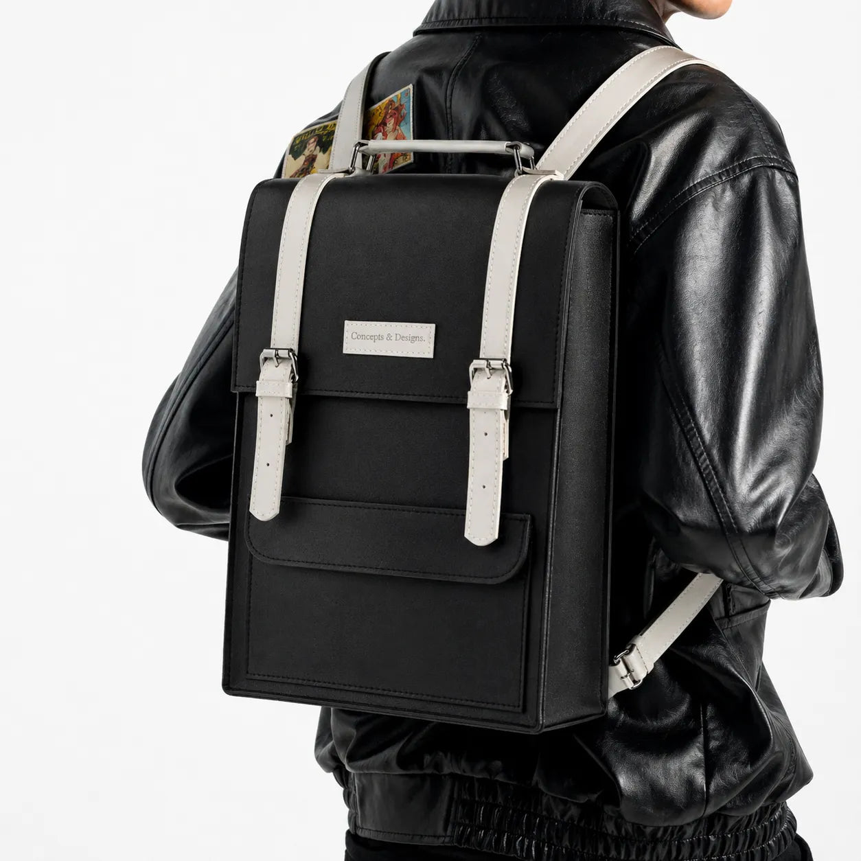 Person wearing a black backpack with white straps on a white background
#color_charcoal