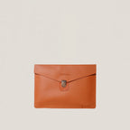 Orange leather clutch bag with a silver clasp on a beige background
#color_chestnut