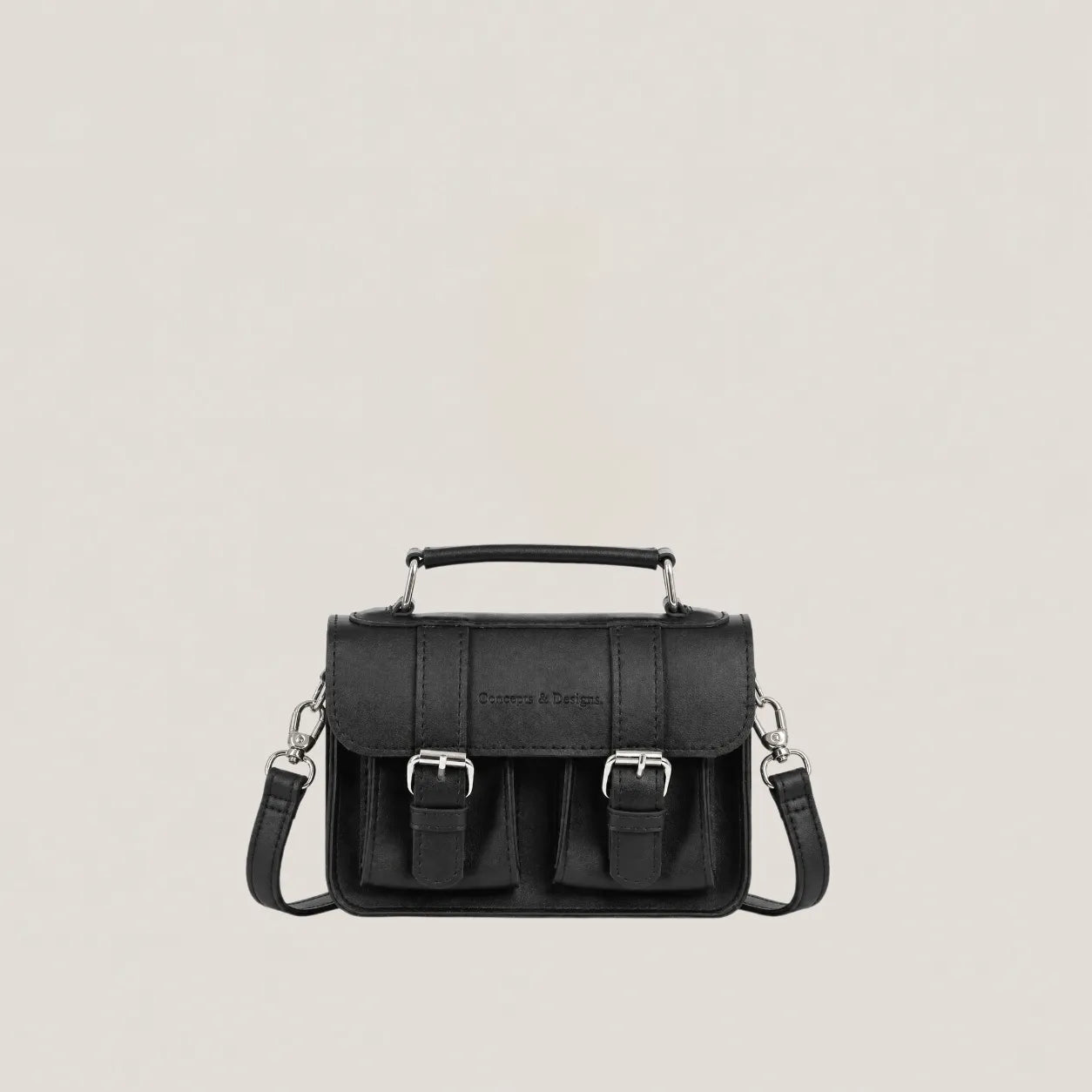 Black handbag with silver buckles on a light gray background
#color_midnight