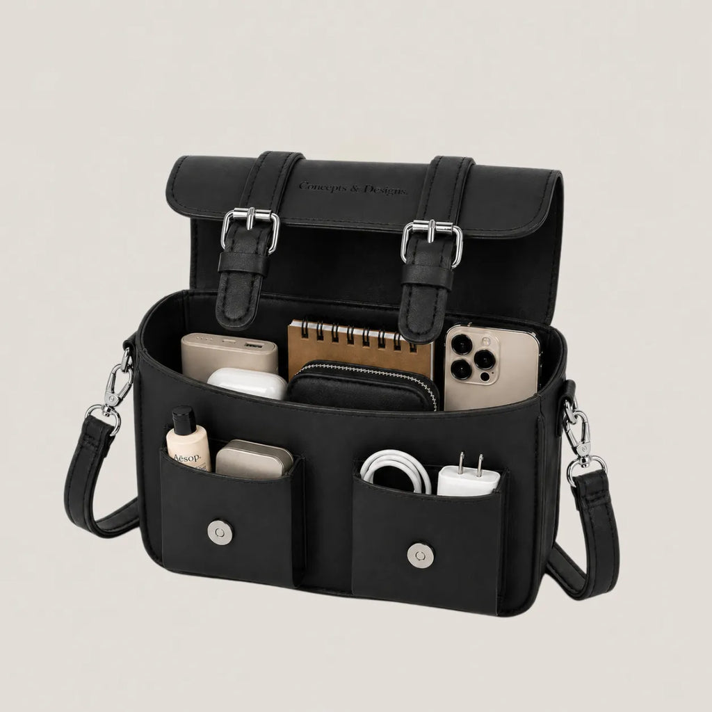 Black organizer bag with various items on a light gray background
#color_midnight