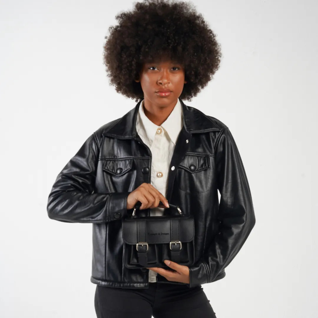 Person wearing a black leather jacket with a visible brand logo on a white background
#color_midnight