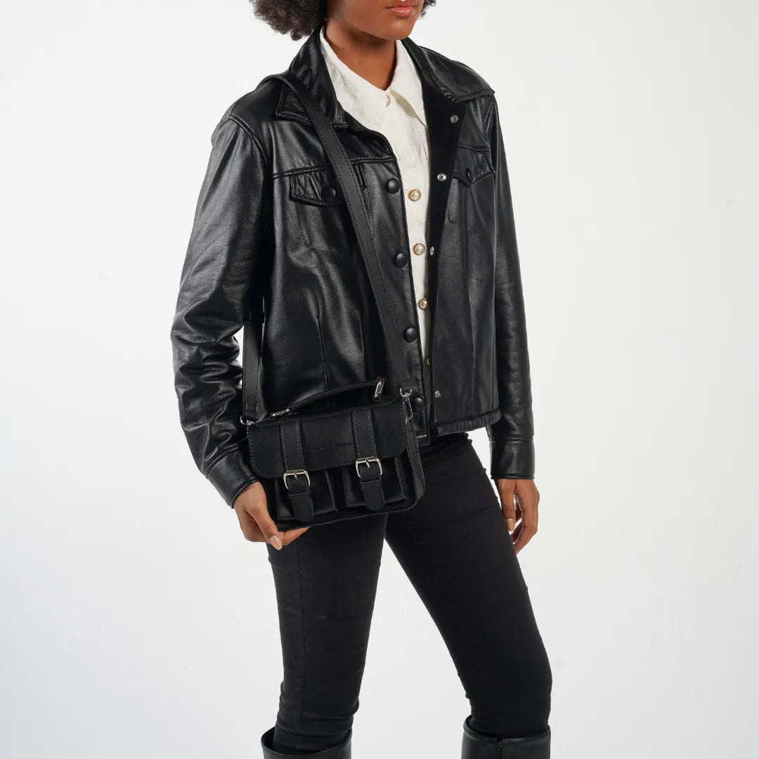 Person wearing a black leather jacket with a white shirt underneath on a white background
#color_midnight