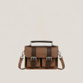 Brown leather satchel bag with silver buckles on a beige background
#color_umber