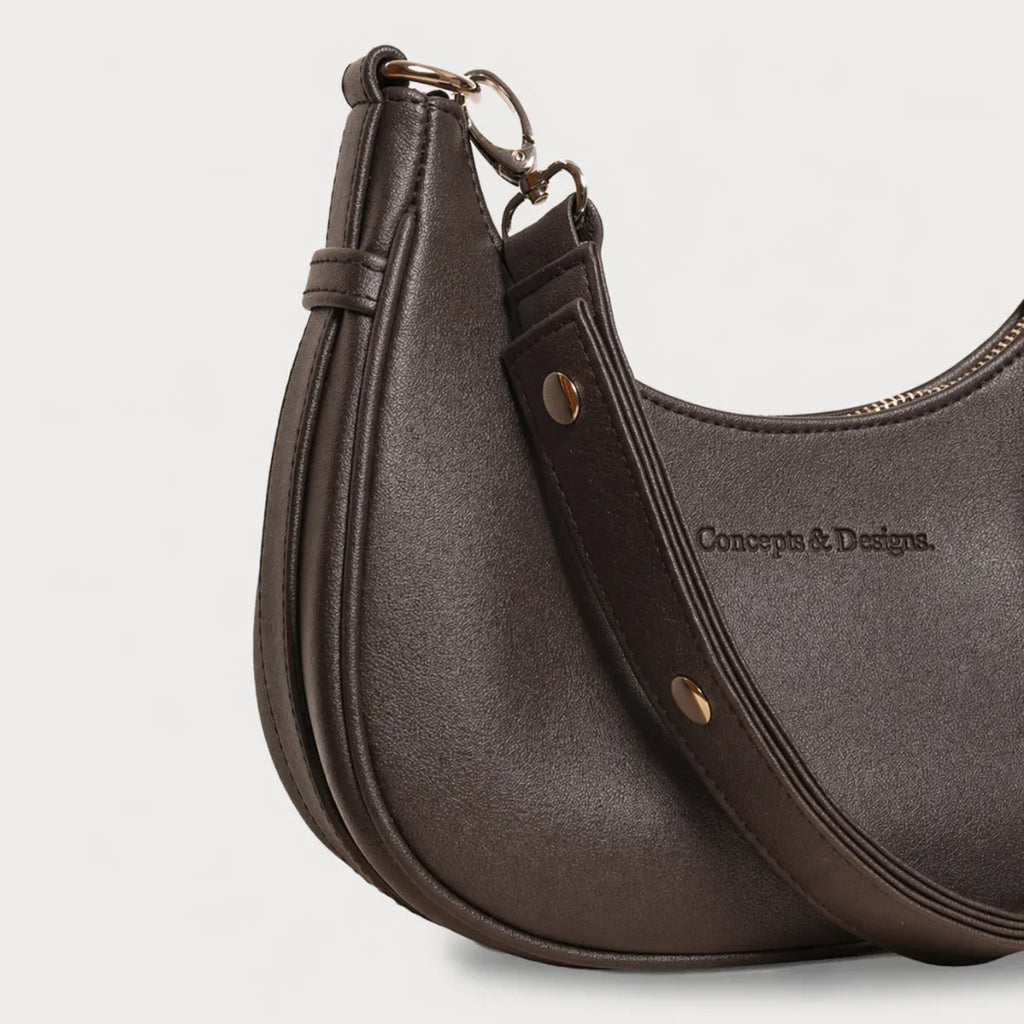 A close up of a brown crescent-shaped bag
#color_brown