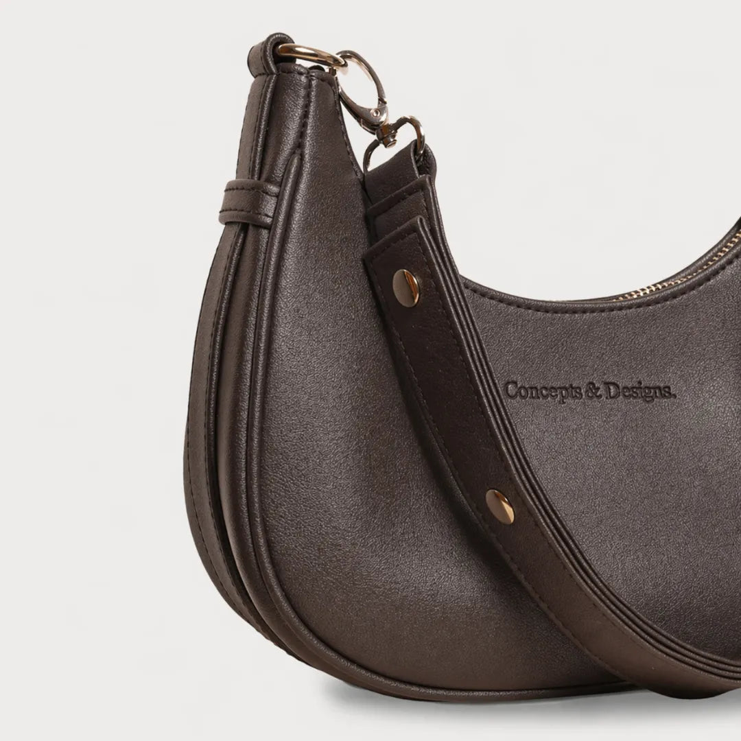 A close up of a brown crescent-shaped bag
#color_brown