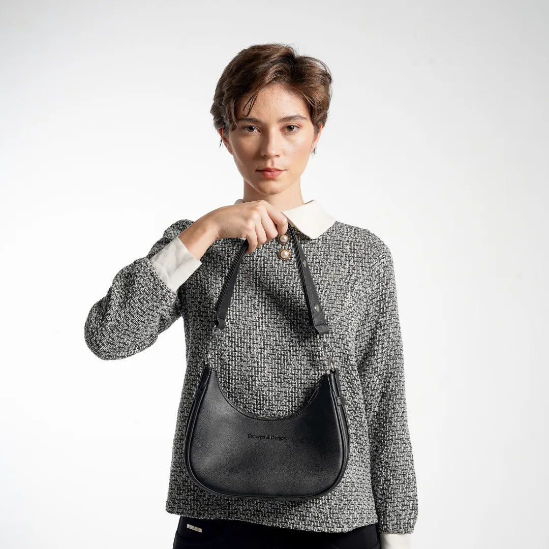 Person wearing a textured sweater with a black backpack on a white background
#color_midnight